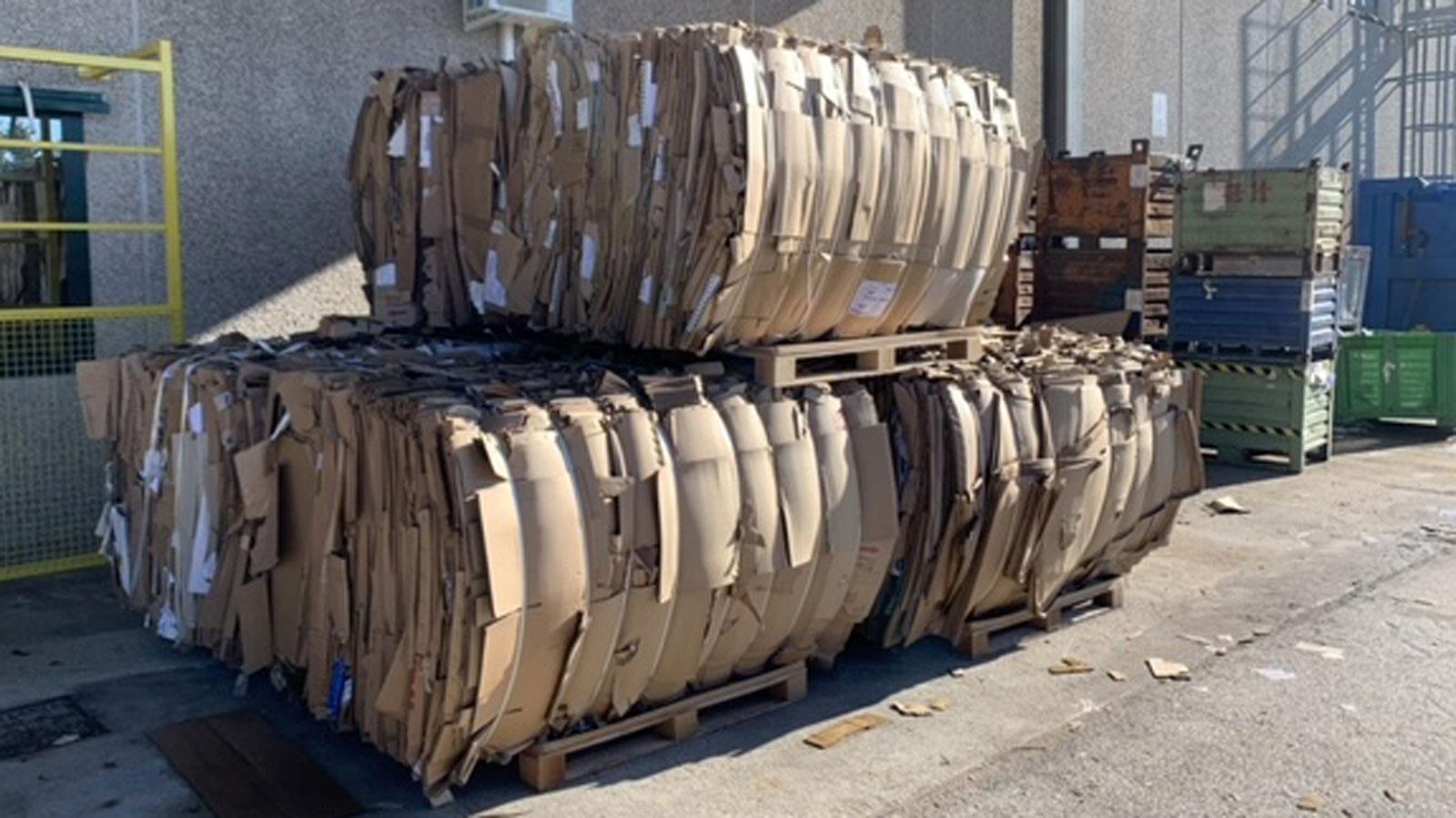 Cardboardbales stacked on each other outside