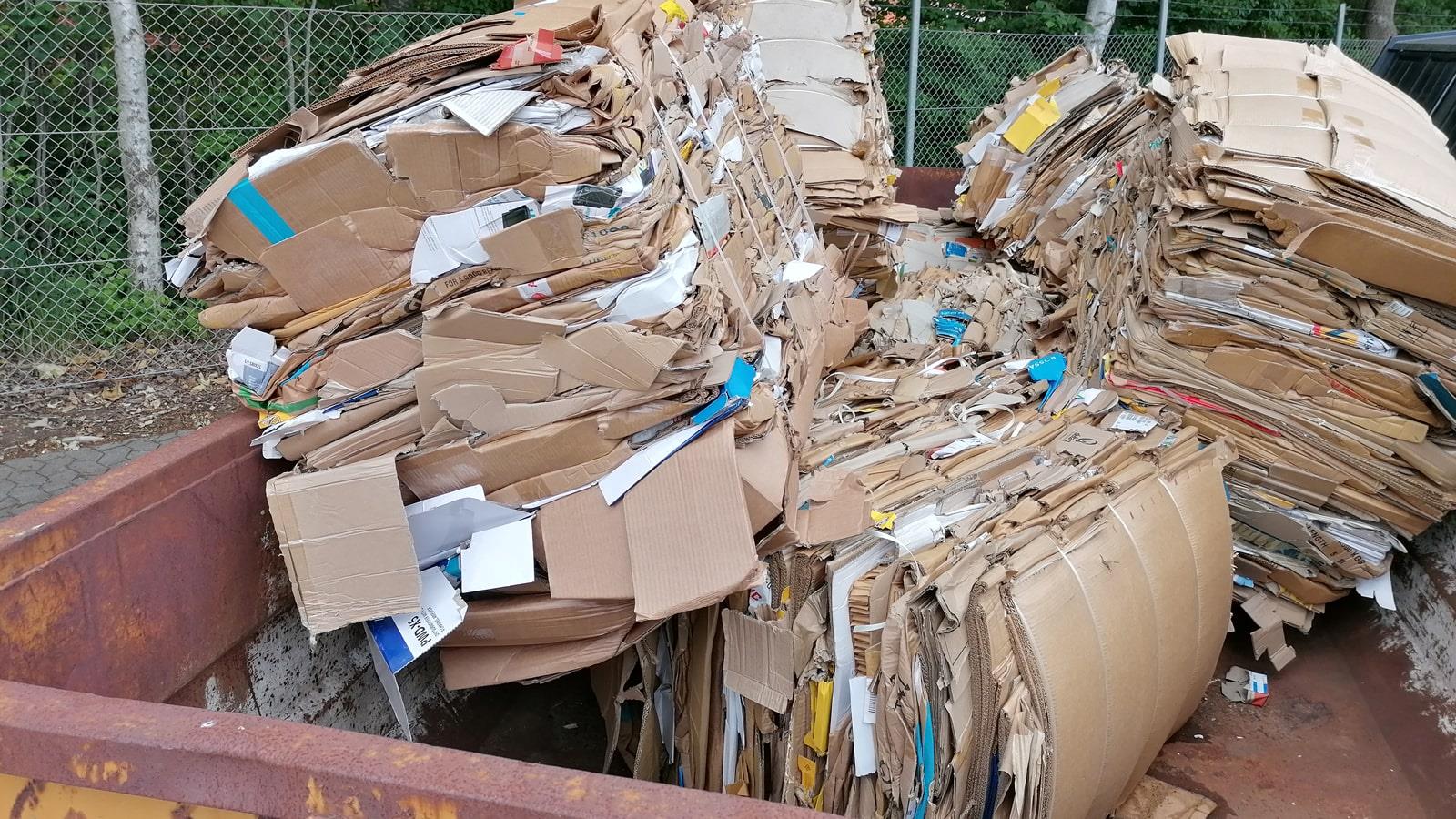 Compressed cardboard bales in open container