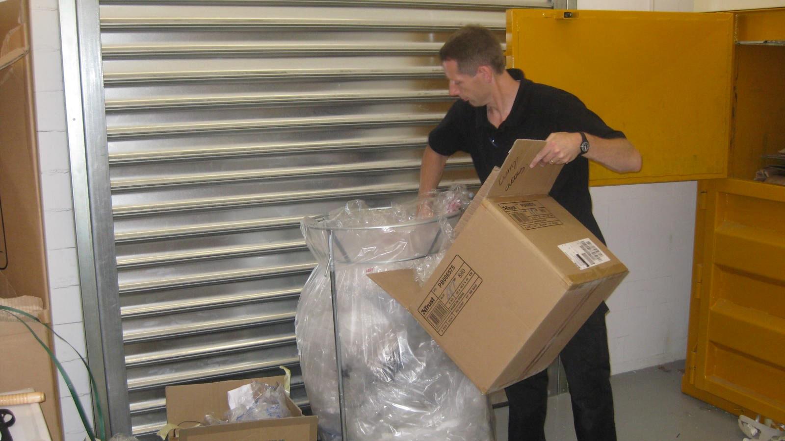 Employee from Media Markt puts soft plastic waste in recyling rack