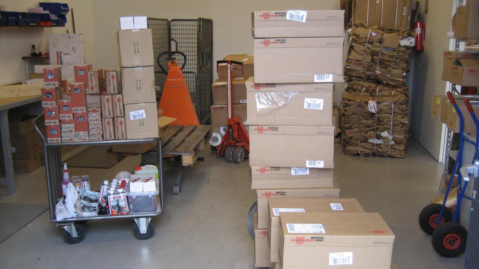Boxes with goods and stacked cardboard bales in Würth storage room